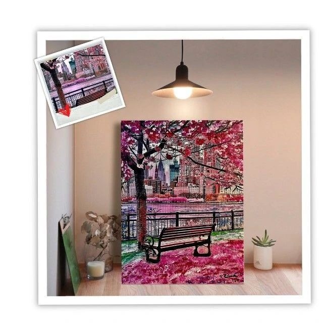 Colorful artwork of a park scene with cherry blossoms and a bench, displayed in a cozy interior setting, highlighting urban beauty.