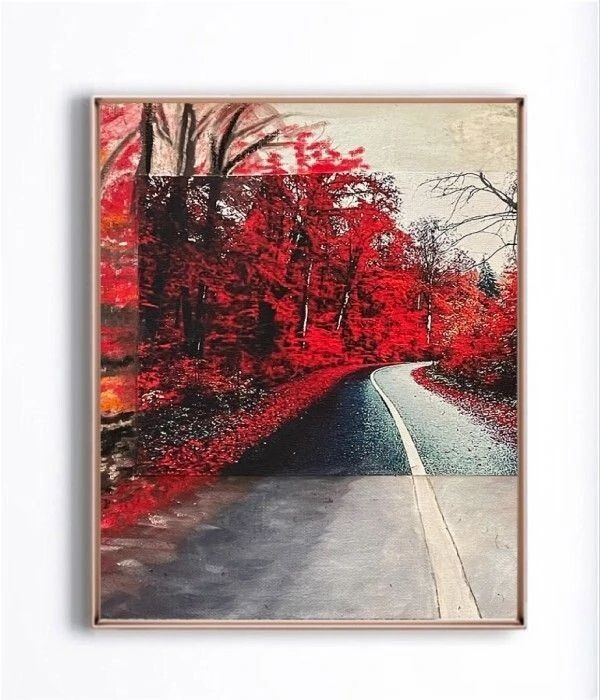 Winding road through vibrant red and orange autumn trees, creating a striking contrast against a gray sky. Perfect for nature and seasonal themes.