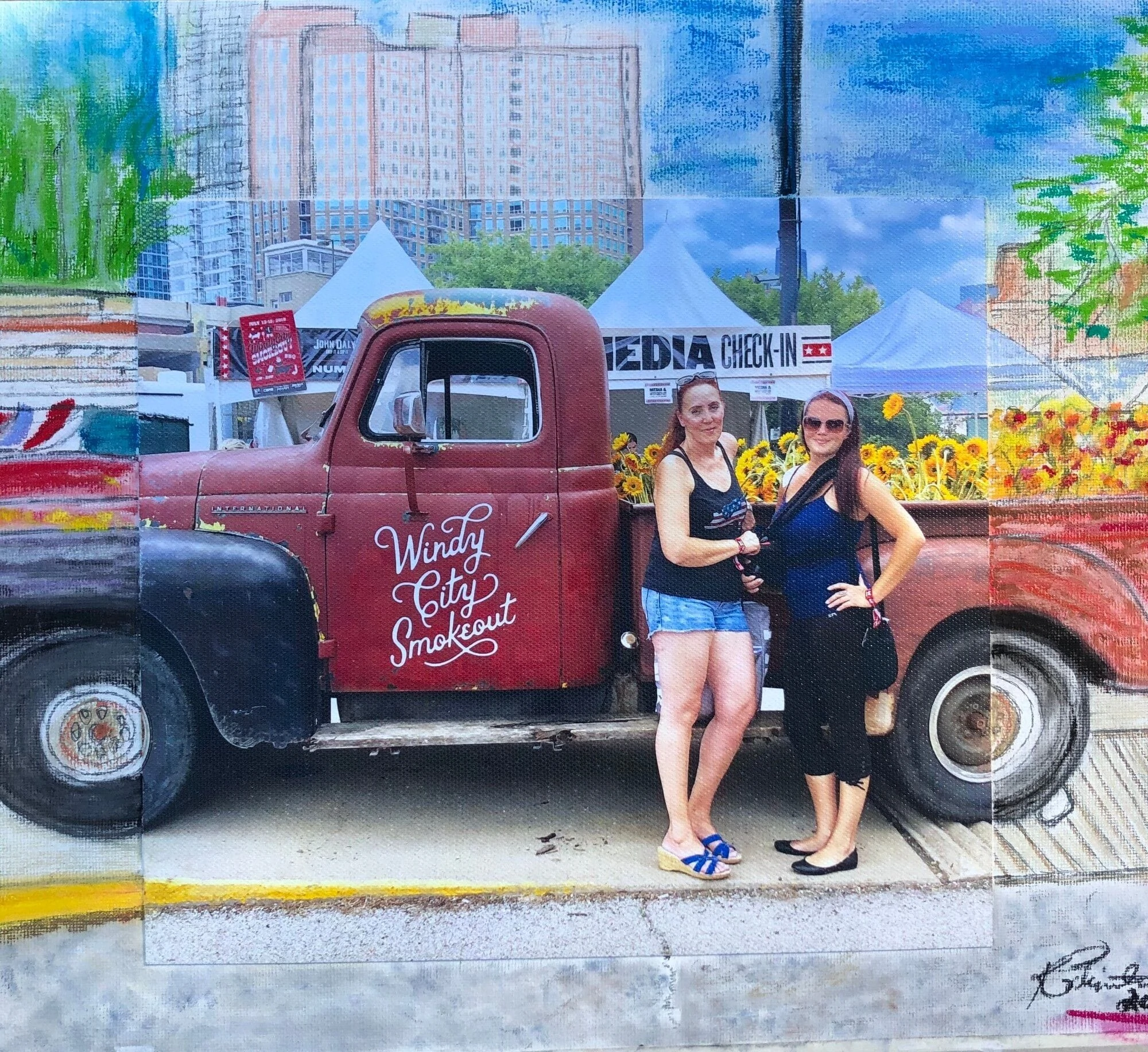 Two women pose next to a vintage red truck decorated with sunflowers, promoting the "Windy City Smokeout" at a lively outdoor event.